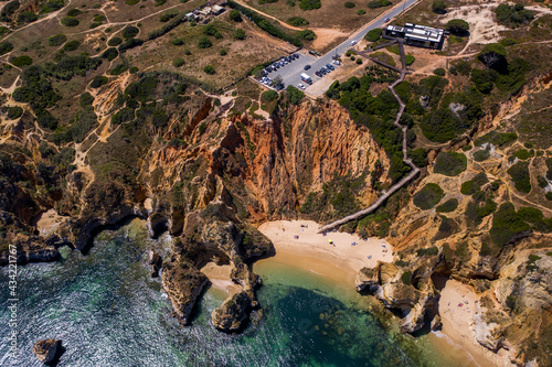 Camilo Beach in Lagos, Algarve - Portugal. Portuguese southern golden coast cliffs. Sunny day aerial view photo