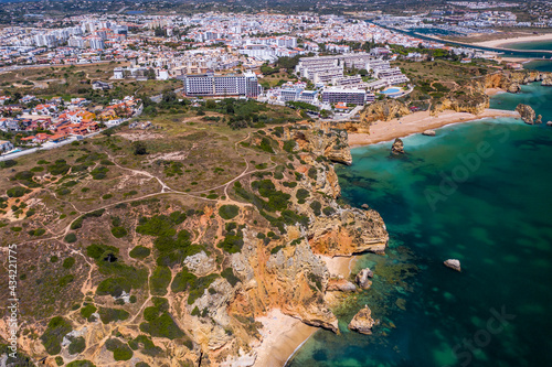 Camilo Beach in Lagos, Algarve - Portugal. Portuguese southern golden coast cliffs. Sunny day aerial view