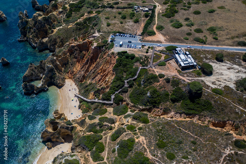 Camilo Beach in Lagos, Algarve - Portugal. Portuguese southern golden coast cliffs. Sunny day aerial view
