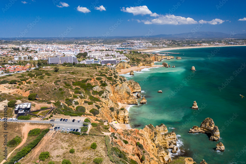Aerial view of golden coast cliffs of portuguese southern beaches in Lagos City, Algarve, Portugal.