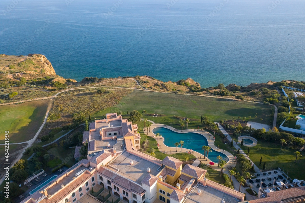 Fototapeta premium Canavial Beach. Portuguese southern golden coast cliffs. Aerial view over city of Lagos in Algarve, Portugal.