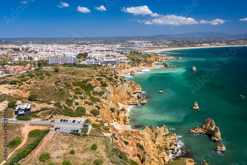 Aerial view of golden coast cliffs of portuguese southern beaches in Lagos City, Algarve, Portugal.