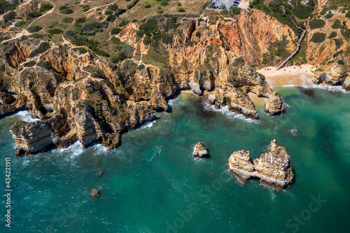 Camilo Beach in Lagos, Algarve - Portugal. Portuguese southern golden coast cliffs. Sunny day aerial view