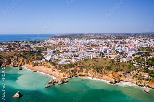 Dona Ana Beach in Lagos, Algarve - Portugal. Portuguese southern golden coast cliffs. Aerial view with city in the background. Camilo and pinhao beach. © Miguel