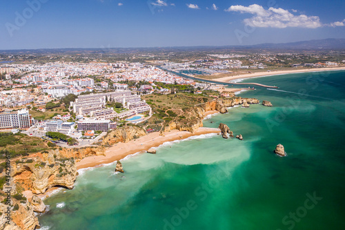 Dona Ana Beach in Lagos, Algarve - Portugal. Portuguese southern golden coast cliffs. Aerial view with city in the background