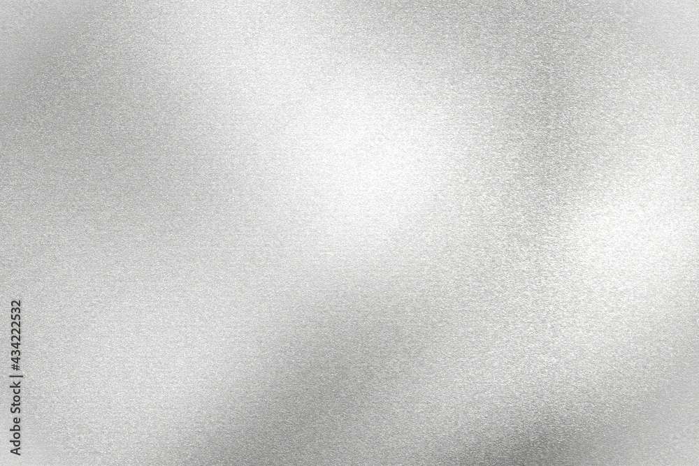 Light shining on silver painted metal wall with copy space, abstract texture background Light shining on silver painted metal wall with copy space, abstract texture background