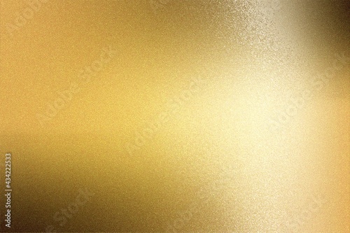 Light shining on gold painted metal plate with copy space, abstract texture background