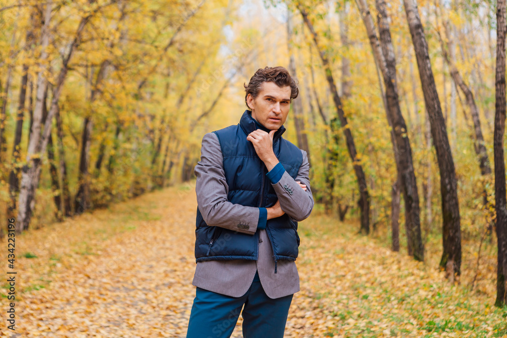 Tall handsome man walking in the autumn alley Tall handsome man walking in the autumn alley