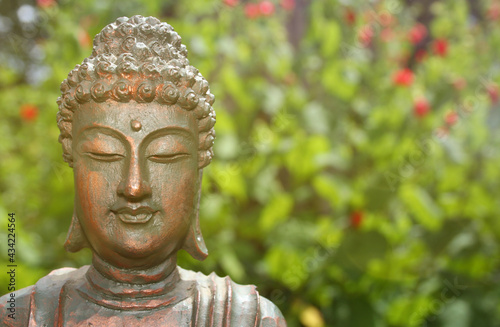 Buddha Statue in Outdoor Garden With Blurred Background