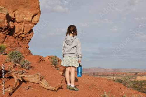 Girl hiking in a desert.