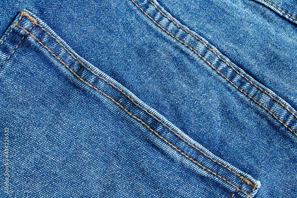 Blue jeans close up. Light blue thick fabric for trousers. Blue jeans close up. Light blue thick fabric for trousers.