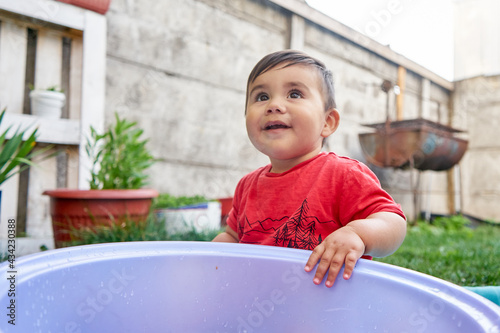 baby playing in garden photo