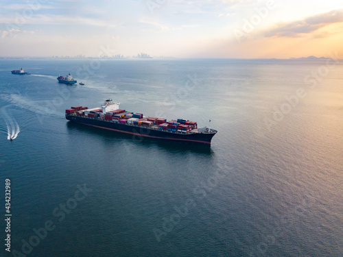 Aerial view from drone, a cargo vessel with peaceful sea in beautiful scenic sky. Professional business logistics and transportation of cargo ship.