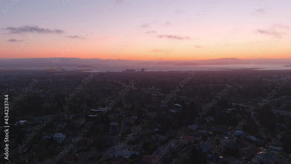 right-to-left aerial flyover of city suburbs at dusk right-to-left aerial flyover of city suburbs at dusk