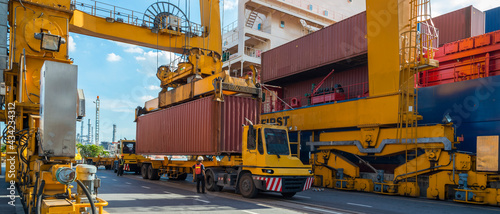 crane loading container box to container cargo freight ship in port shipping containers a logistics business and global trading. logistics, global business and transportation concept