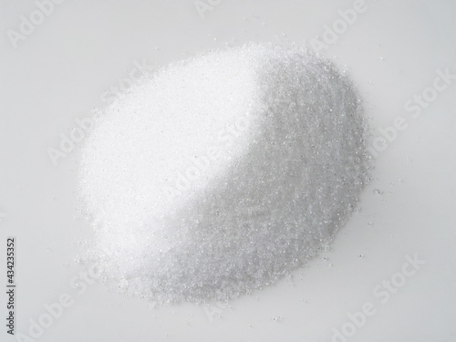 pile of crystalline extract of stevia on white photo