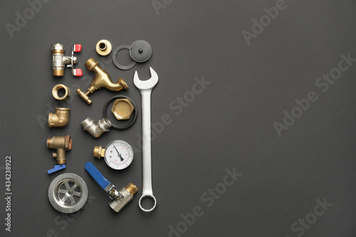 Set of plumber's items on dark background