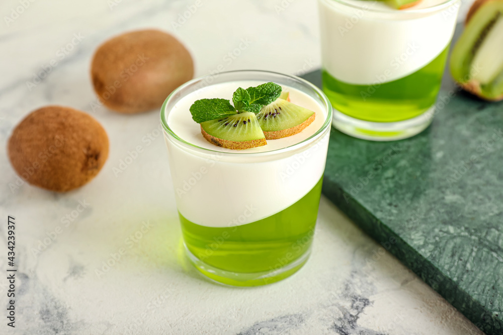 Glasses of tasty jelly with kiwi on light background Glasses of tasty jelly with kiwi on light background