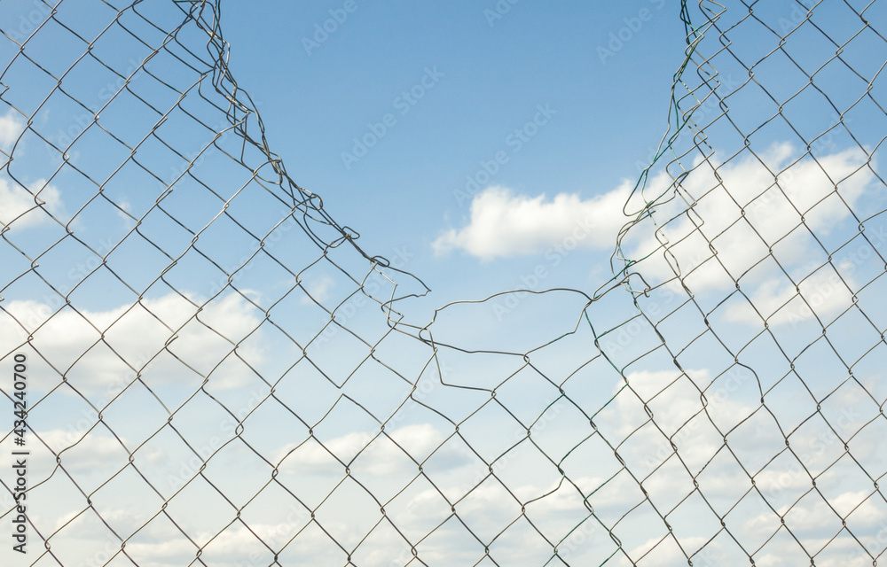 Broken metal mesh fence