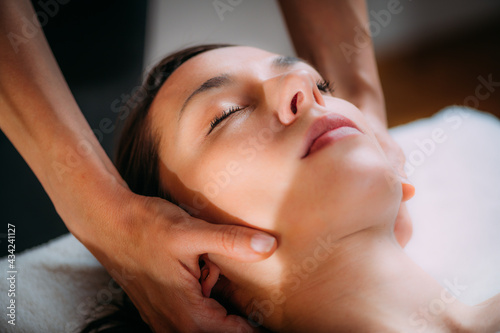 Cranial Osteopathy. Therapist Massaging Woman’s Head.
