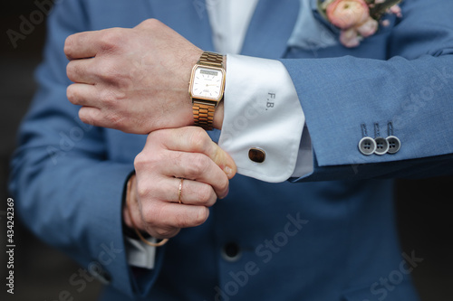 Groom showing his cufflinks