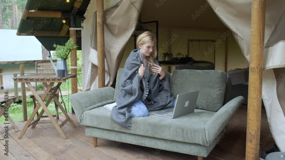 woman working at laptop in luxury camping woman working at laptop in luxury camping