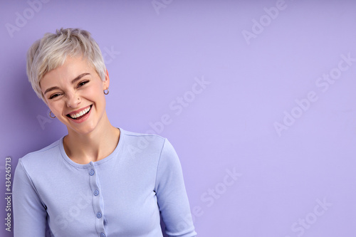 Excited woman with short hair laughing, feeling happiness, have fun. Caucasian young adult female in casual shirt posing at camera, having perfect toothy smile. Human emotions concept