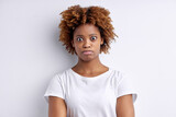 Shocked Afro American woman gazes surprised isolated over white background with blank empty space for your information. Female looks surprisingly, realizes bad news