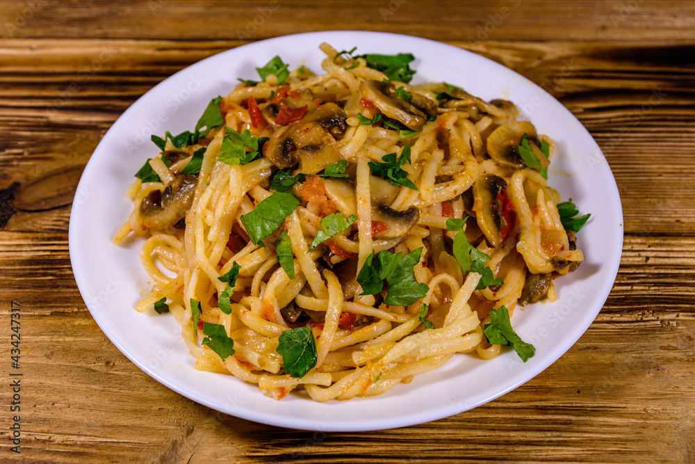 Pasta with mushrooms and tomato sauce in a plate