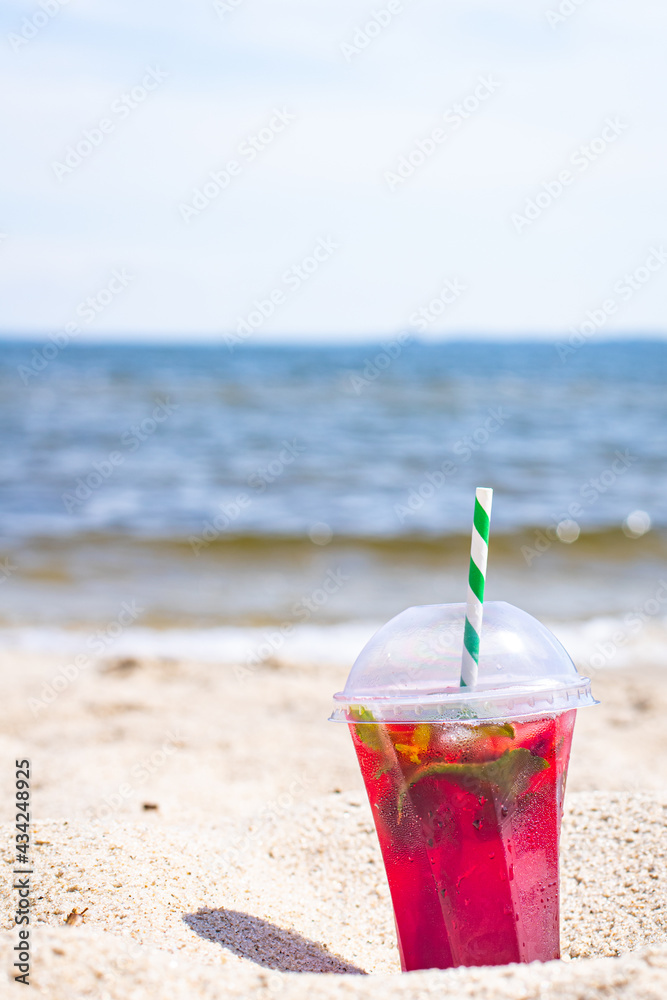 lemonade red soda cherry or strawberry fresh juice, sea coast shore, summer surf wave background refreshing drink relax positive mood vacation top view lemonade red soda cherry or strawberry fresh juice, sea coast shore, summer surf wave background refreshing drink relax positive mood vacation top view