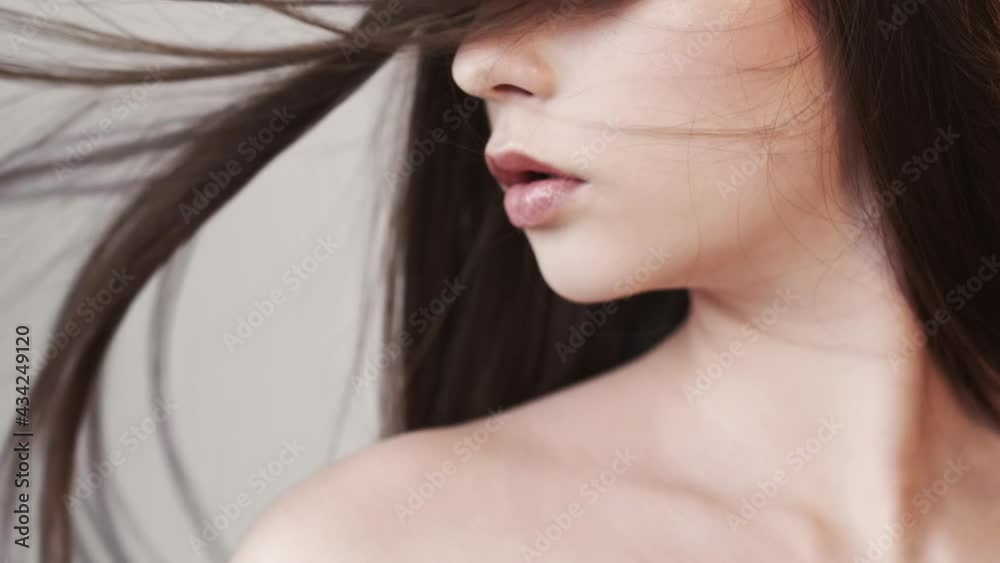 Sensual woman. Tranquility mind. Natural beauty. Enjoying peace. Eternity dream. Profile brunette lady with long silky hair posing wind blow isolated neutral slow motion blur.