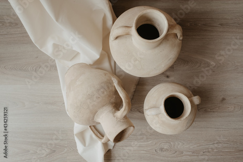 clay jug on wooden background