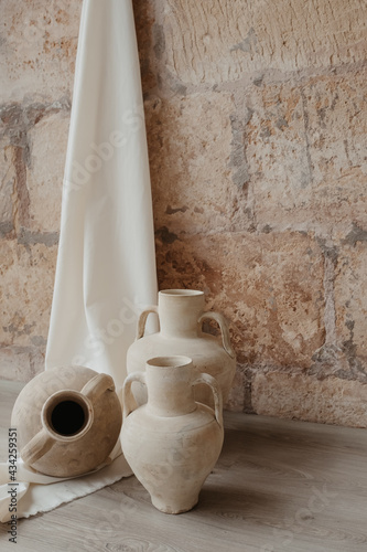 clay pots on stone wall in a traditional mediterranean house