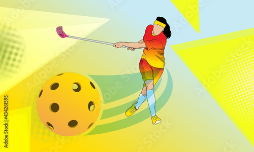 A girl with a stick hits a ball, plays floorball.