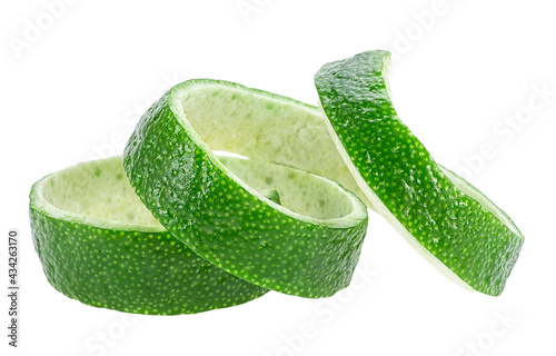 Peel of fresh ripe lime on a white background. Curly lime twist.