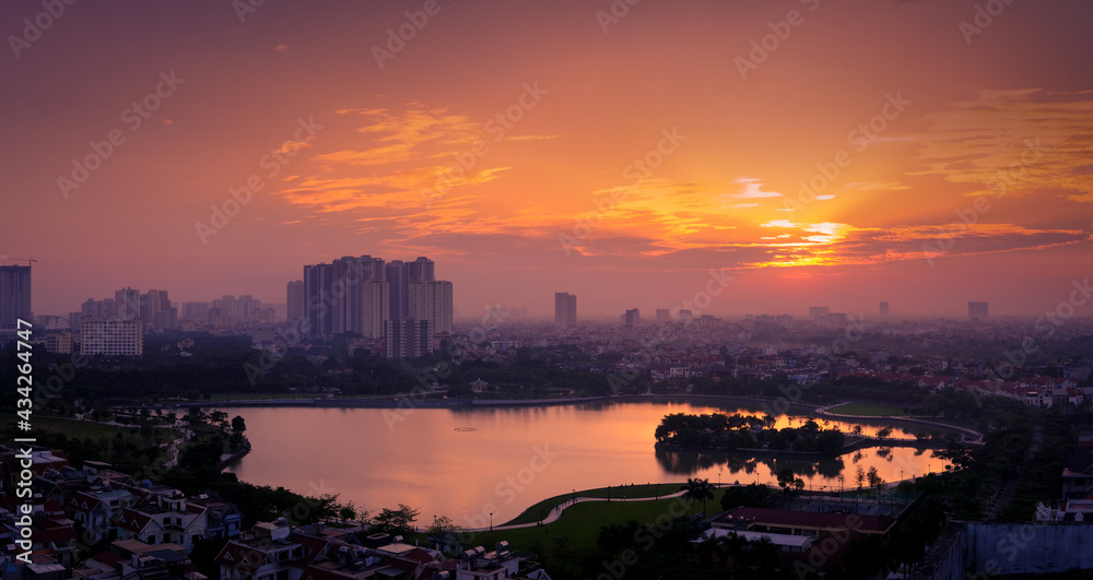 Sunset over the city. Panorama sunset city in the summer