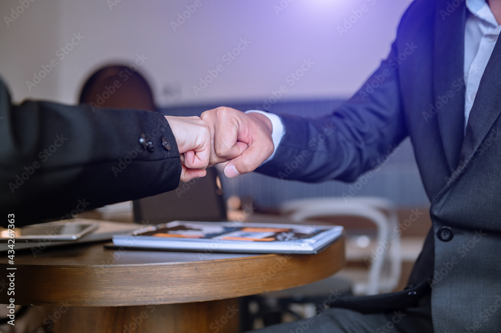 Business handshake closing a deal with blur background of people.