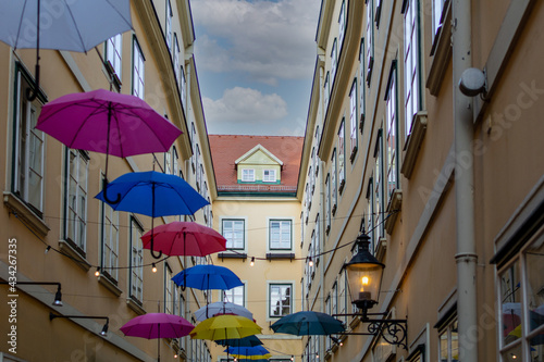 Umbrellas with different colors hanging in the Courtyard and public passage Suennhof in the 3rd District in Vienna, Austria 