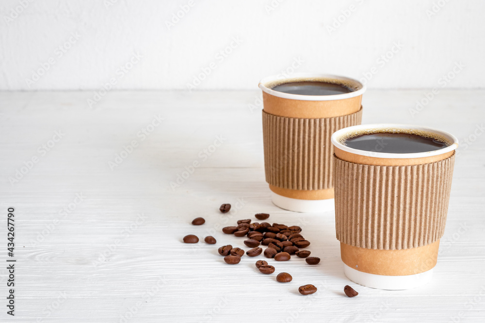 Black coffee in paper cups with beans. Take away coffee background Black coffee in paper cups with beans. Take away coffee background