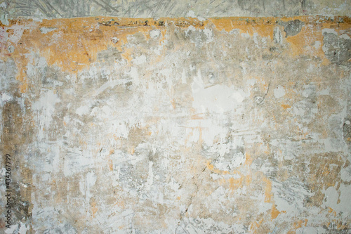 Scratched, cracked, flooded and bruised wall in an old industrial room (basement or warehouse). Industrial, texture or wallpaper background with brick and stains