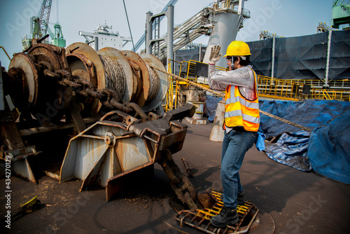 Engineering or foreman controller in action of working command by exciting communicating with the teamworks in order to takes working under safety route regulation during work at site photo