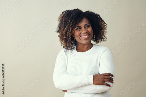 Looking up at copy space African American Smiling Woman Wearing a white sweater photo
