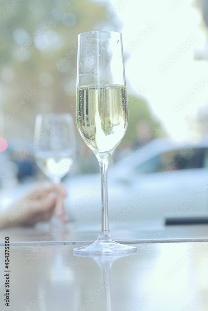 white wine glass in an outdoor cafe, spring view in a restaurant