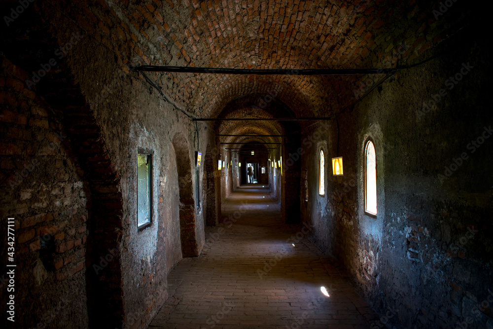 Obraz premium Long brick corridor inside an old medieval castle.
