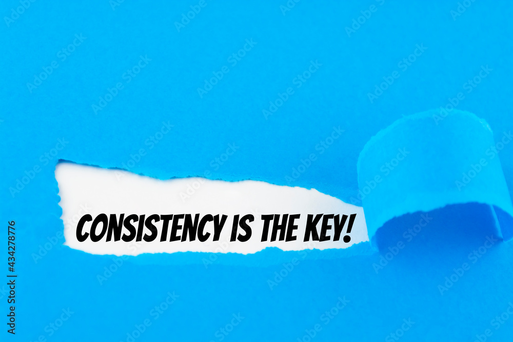 Text Consistency is the key appearing behind ripped blue paper. Text Consistency is the key appearing behind ripped blue paper.