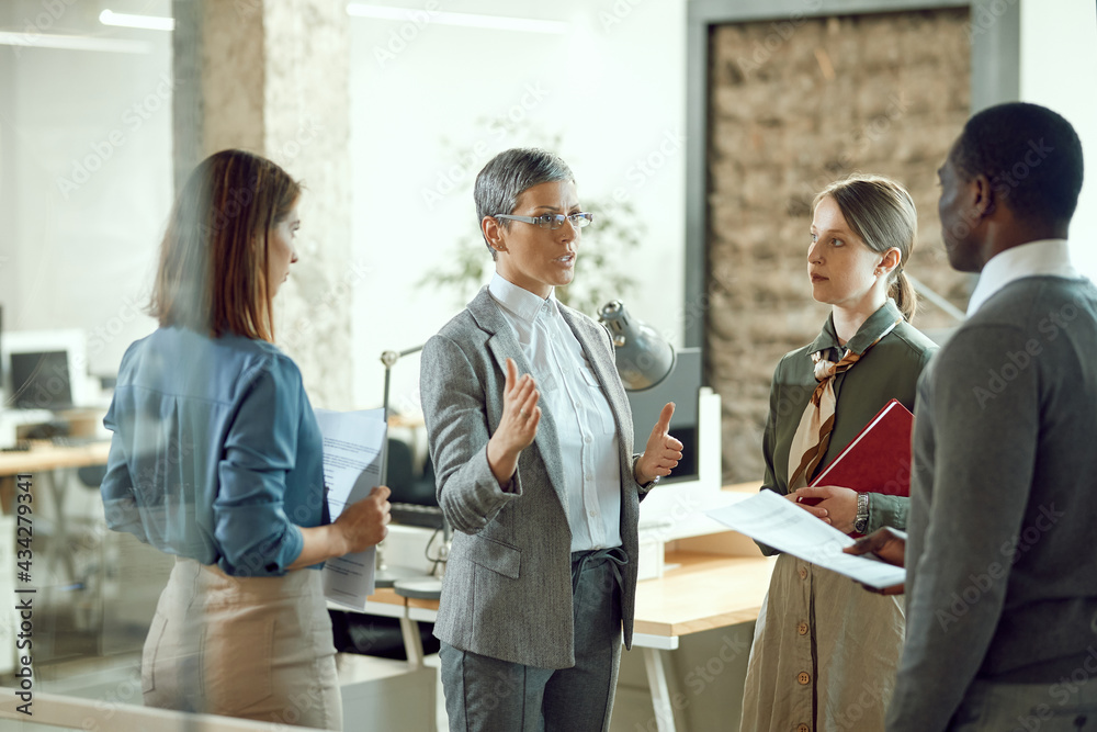 Female business leader having meeting with her team at corporate office. Female business leader having meeting with her team at corporate office.