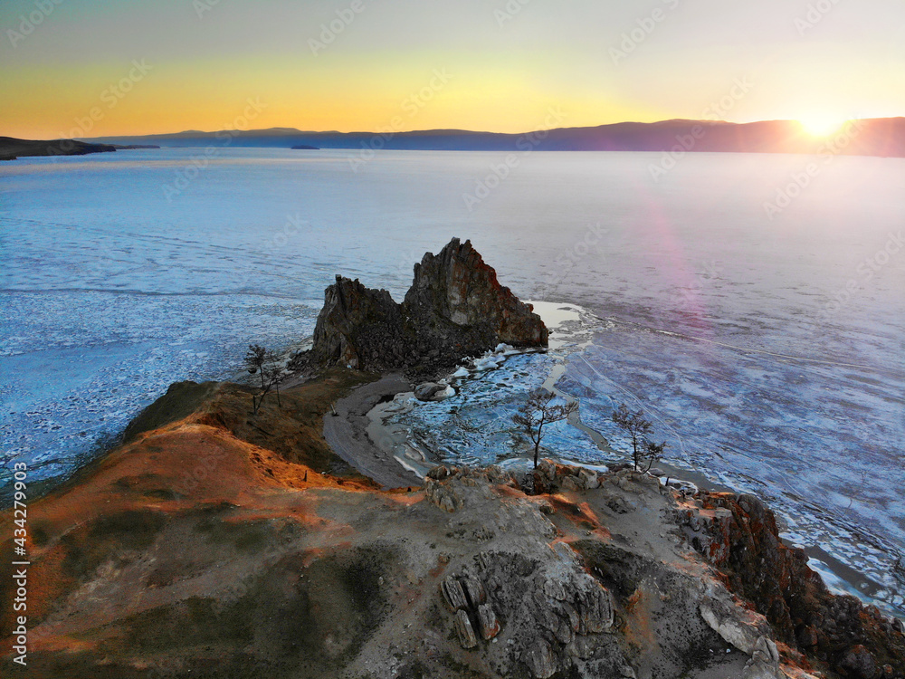 Beautiful aerial view of Cape Burhan or Shamanka Rock, Olkhon Island. Lake Baikal in the spring during the melting of the ice.