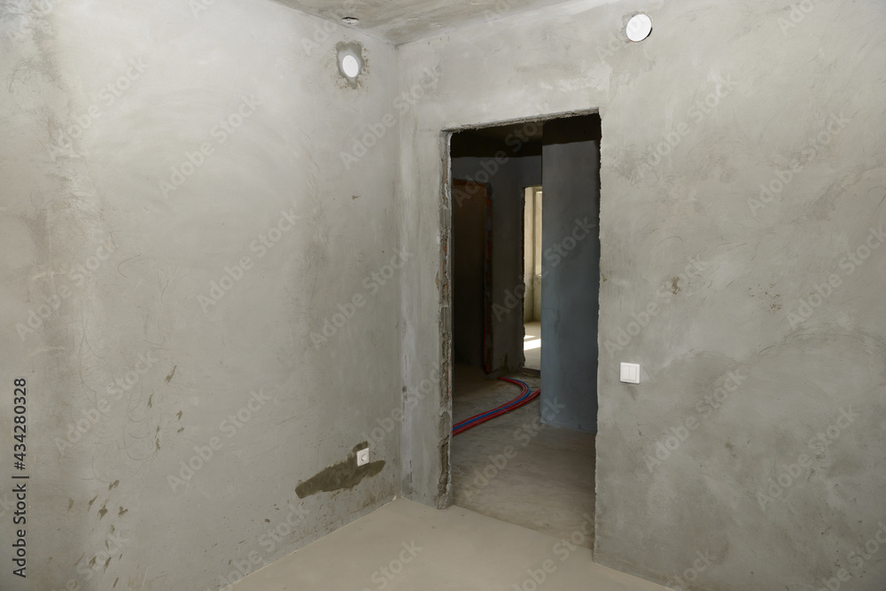 Rooms of the apartment in a new building with rough finishing