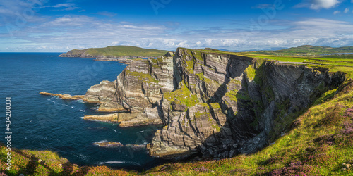 Large panorama with majestic tall Kerry Cliffs and turquoise coloured Atlantic Ocean on a sunny summer day, Portmagee, Ring of Kerry, Ireland