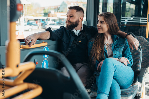 Young romantic couple sitting in a moving bus